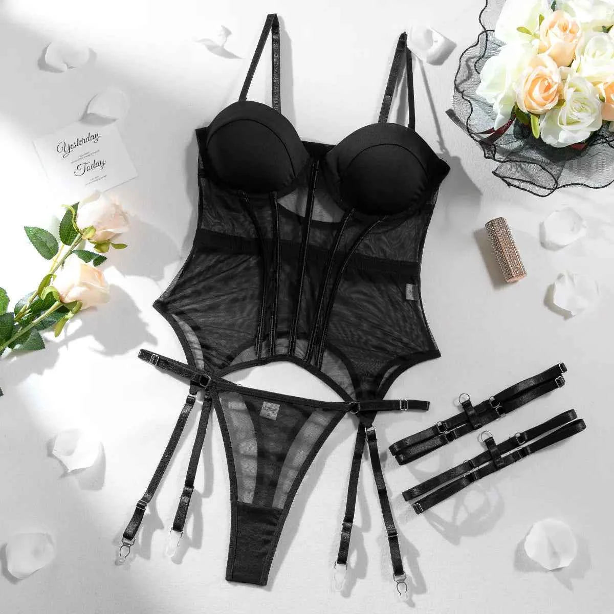 Black lingerie set with floral decorations on a light surface
