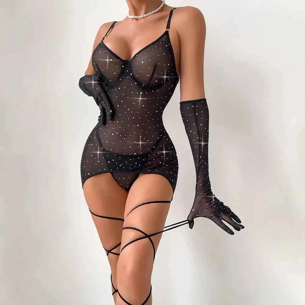 Black sheer bodysuit with sparkling details and black gloves on a plain background
